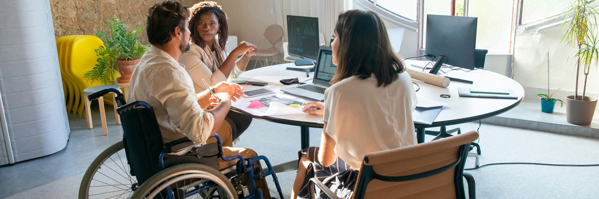 person in wheelchair in group meeting